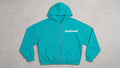 Sudadera con cremallera oversize turquesa con logotipo bombswell en el pecho